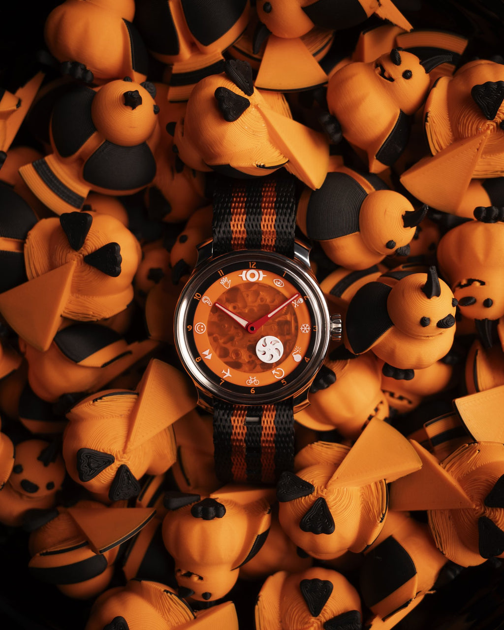 the jack o' lantern on a pile of little pumpkin figures