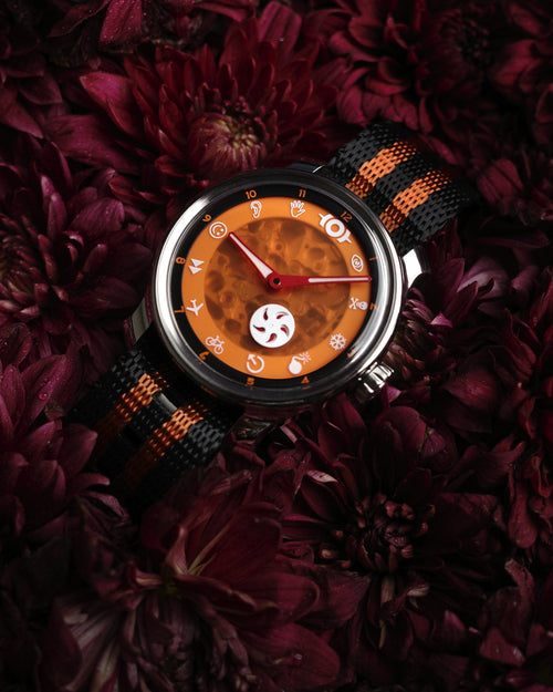 the jack o' lantern lying in dark red flowers