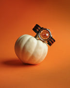 the jack o' lantern strapped round a small white pumpkin